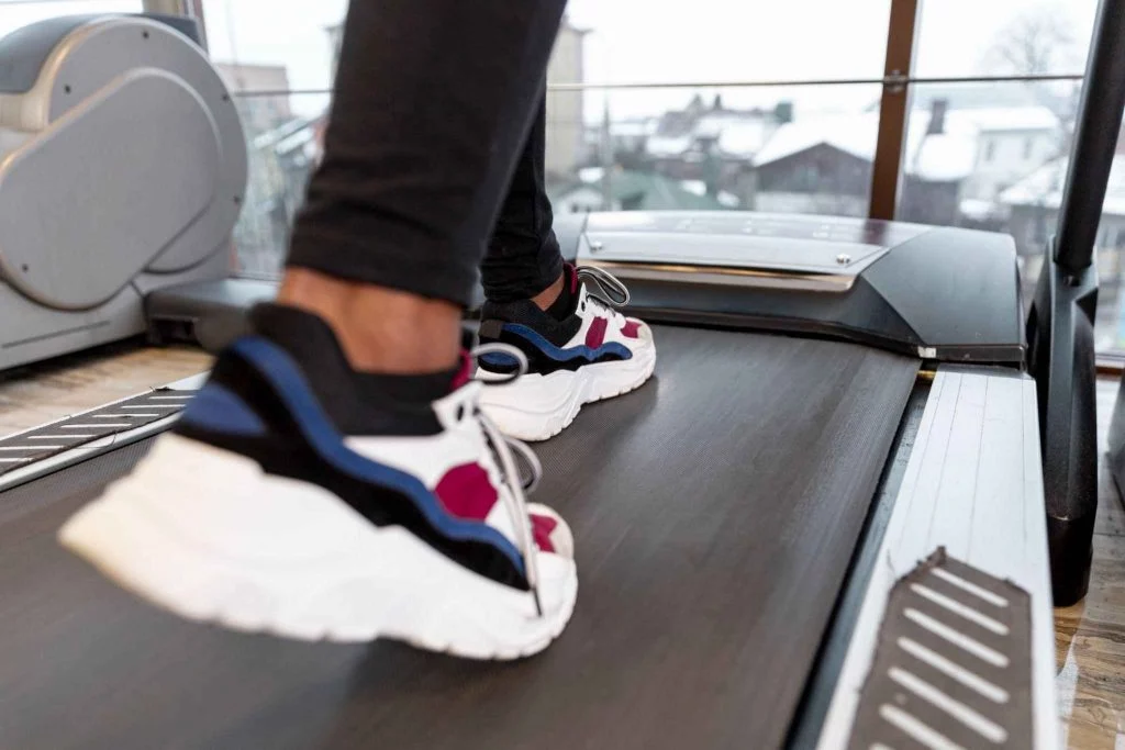 Close-up of colorful sneakers in action during a treadmill workout.