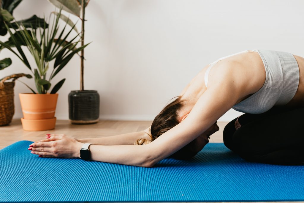 A woman is doing dog position of yoga