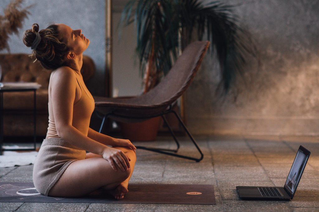 A woman is relaxing when she's being trained in an online class