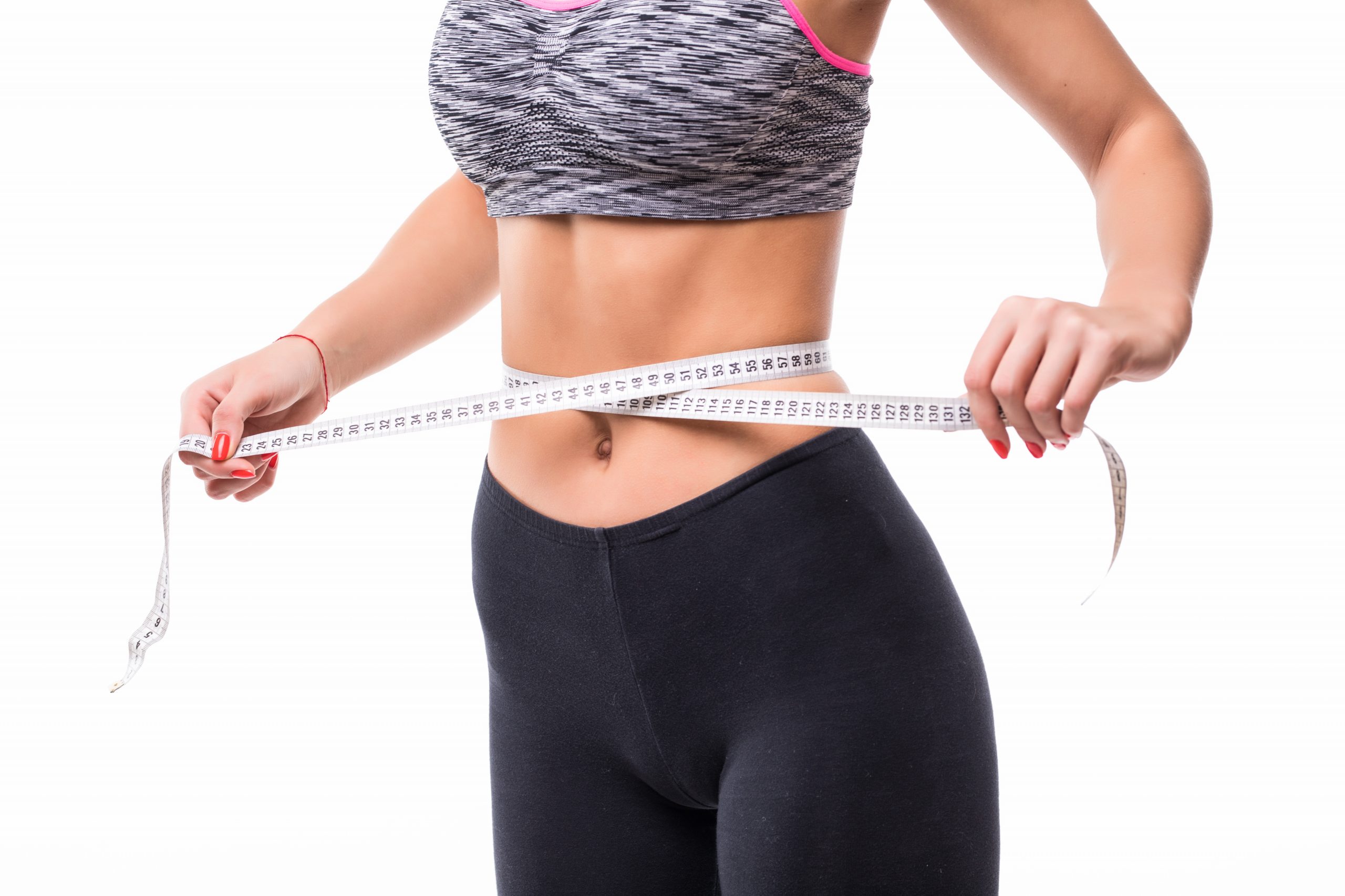 young blonde fitness Woman measuring her body with ruler dressed in fasion sportswear losing weight concept