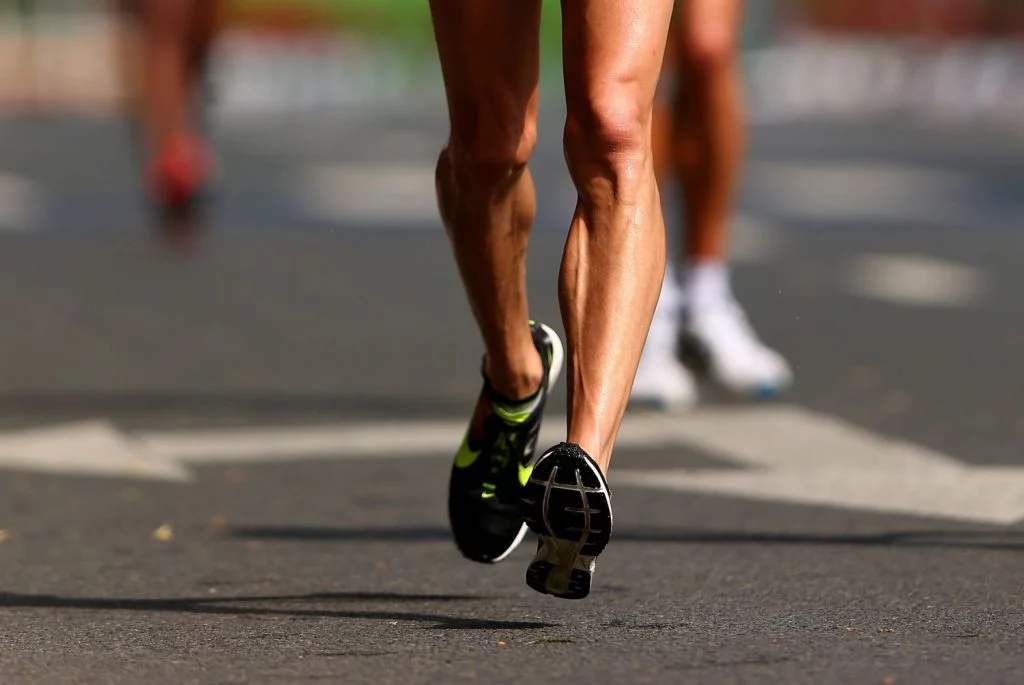 Two feet of a competitor are shown that are running