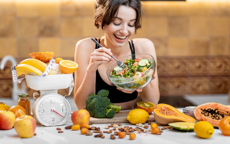 A woman is having a green and healthy salad for losing weight 