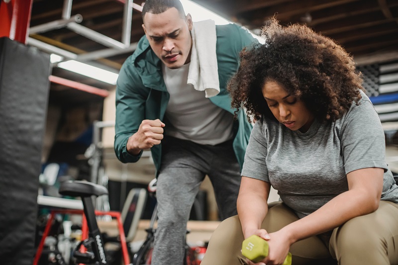 Personal trainer is supporting the client