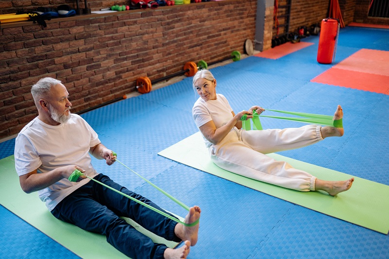 Two female and male seniors are exercising together