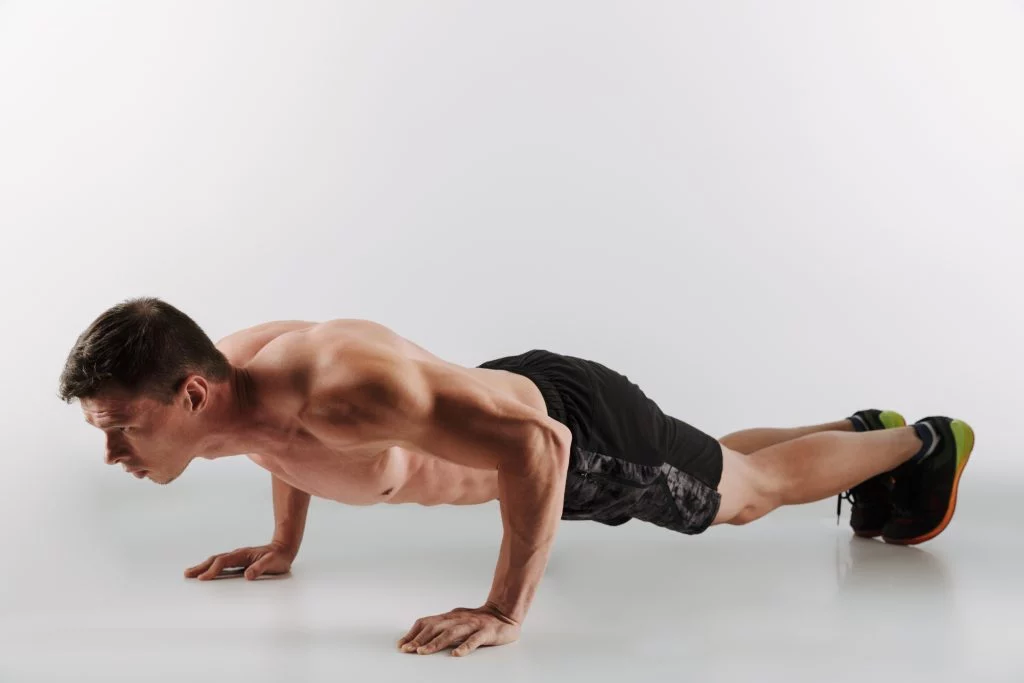 Man performing a push-up to strengthen upper body and core.