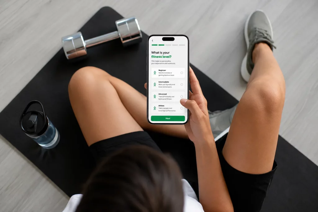Online Training Model A client taking a fitness assessment on her phone to find the right online personal training program.