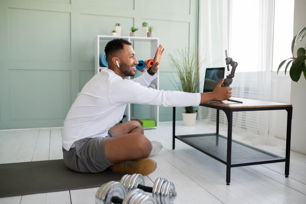 A smiling man connecting with his online weight loss coach during a virtual workout session