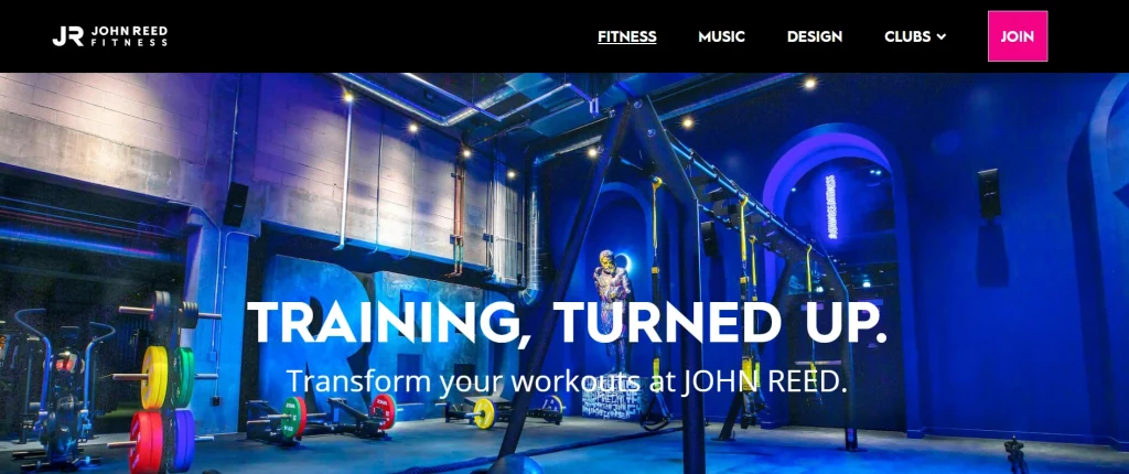 Screenshot of John Reed Fitness website showing a neon-lit gym interior with “Training, Turned Up” headline.