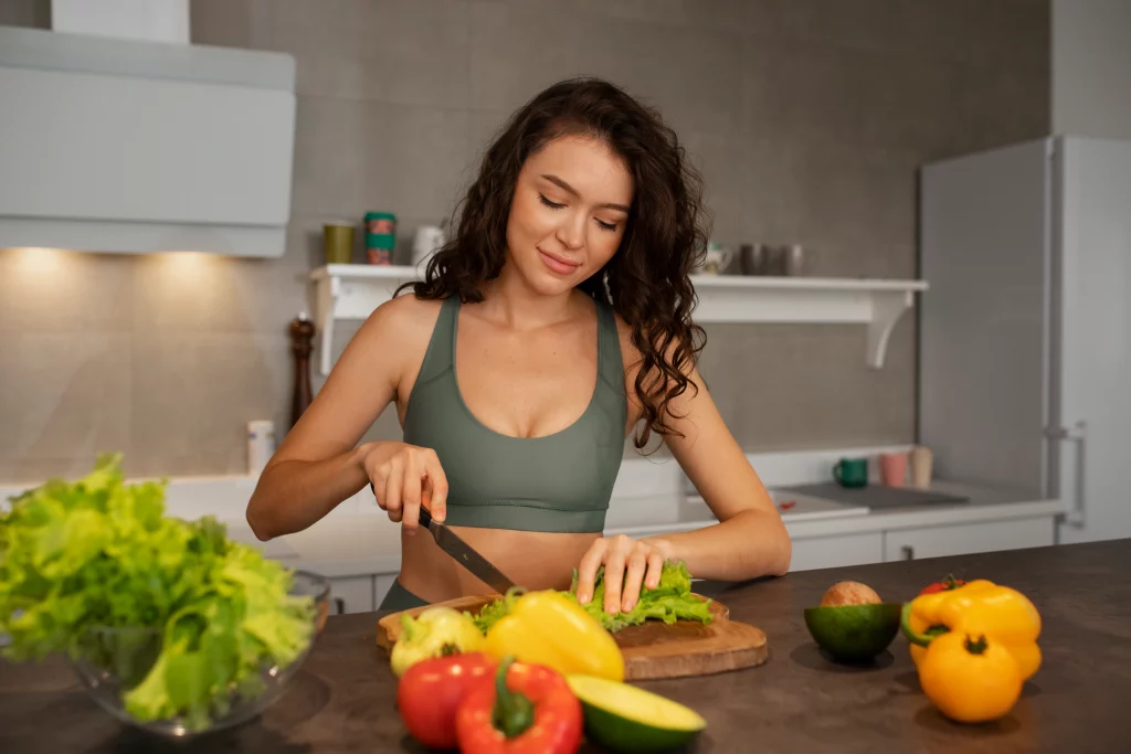 Online Weight Loss for Women A woman preparing a healthy meal as part of guidance from an online weight loss coaches for women.