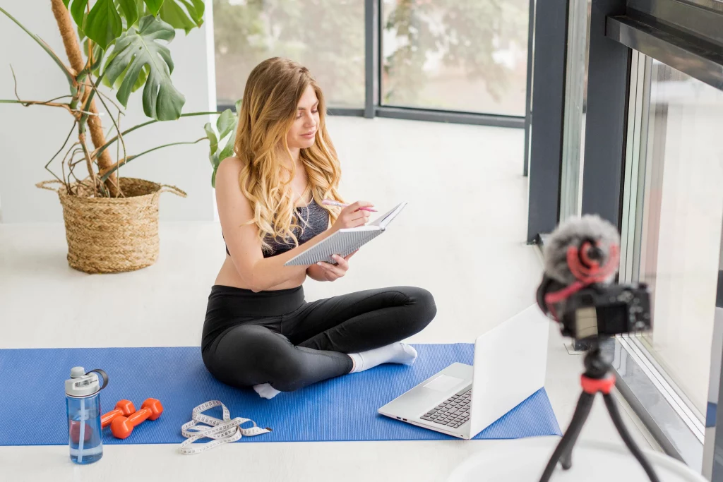 Female online coach for weight loss planning a client program at home during an online video session.