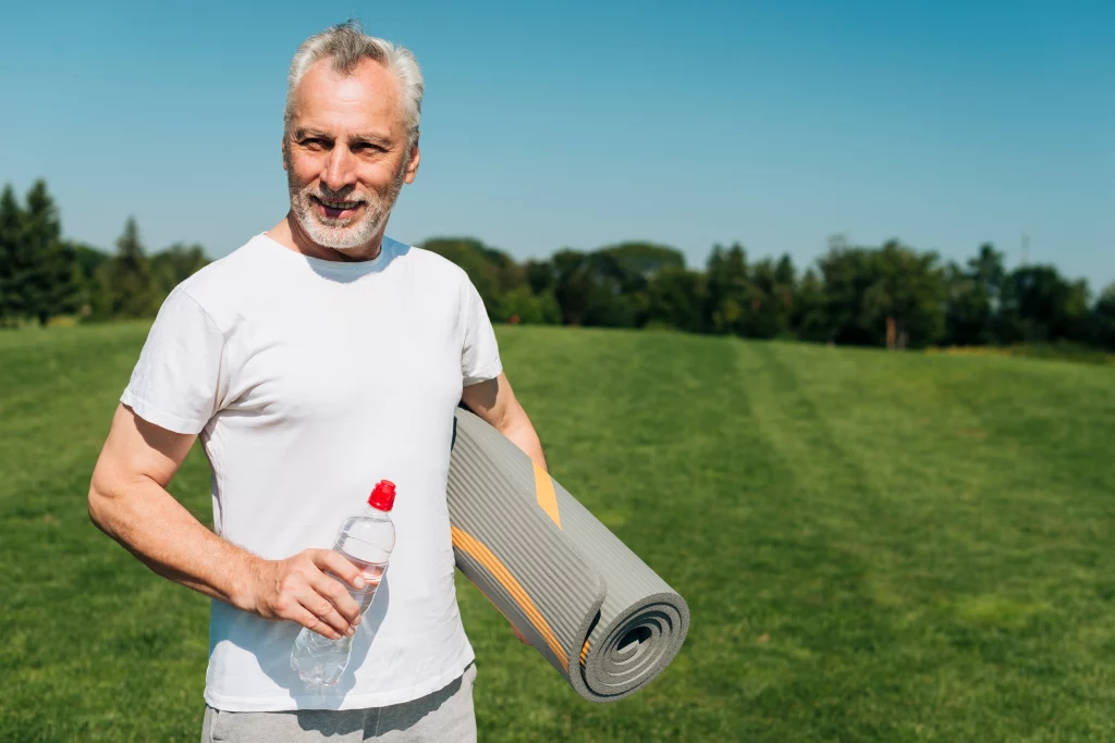 A healthy older man preparing for an outdoor workout with support from an online fitness coach