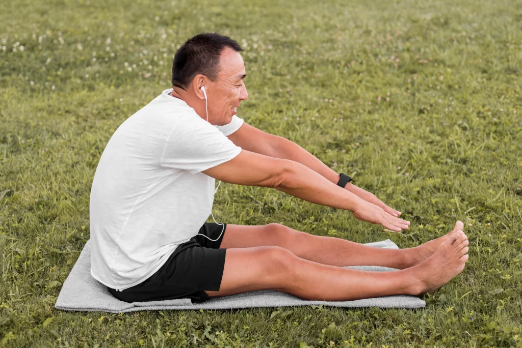 A man stretching outdoors as part of an online fitness coaching program for men over 40