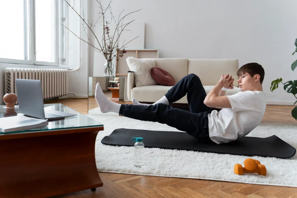 Home workout vs gym comparison showing a man exercising on a mat at home with minimal equipment