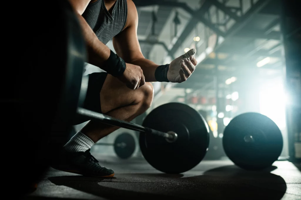 Gym vs home workout comparison showing a person preparing for a strength training session in a gym