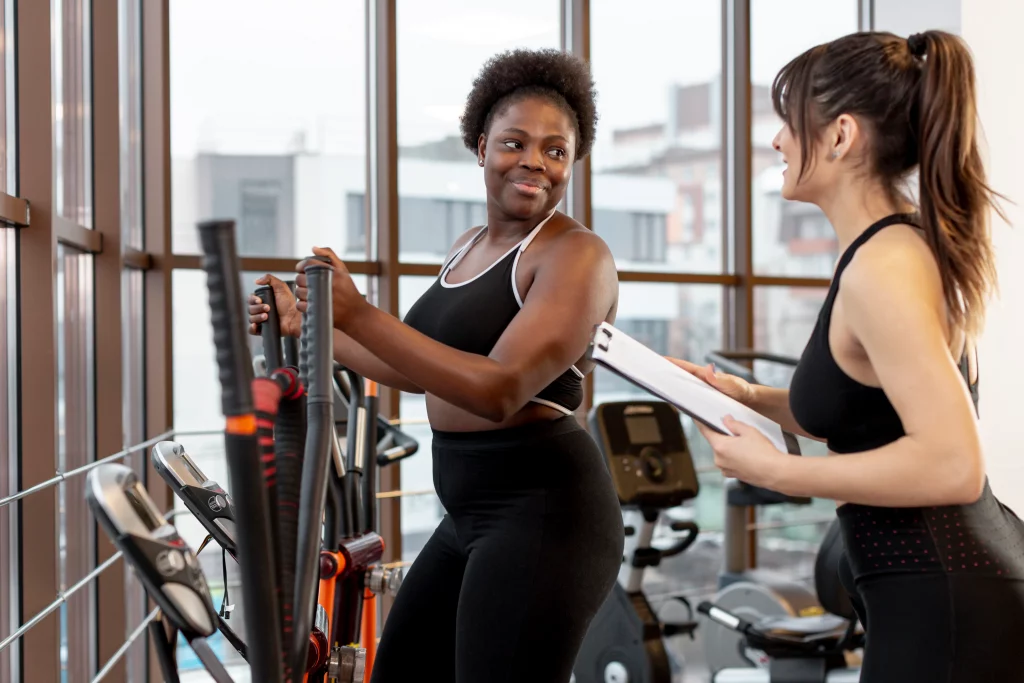 A trainer guiding a warm-up as part of glute exercises for women