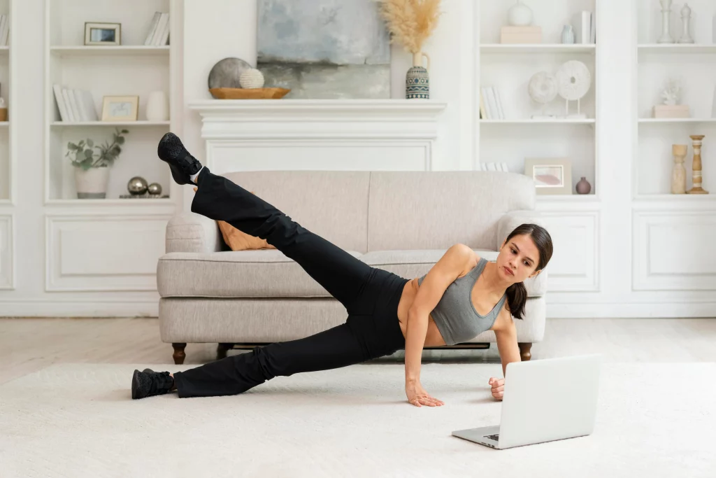 A woman doing a side leg raise as part of glute exercises for women at home 